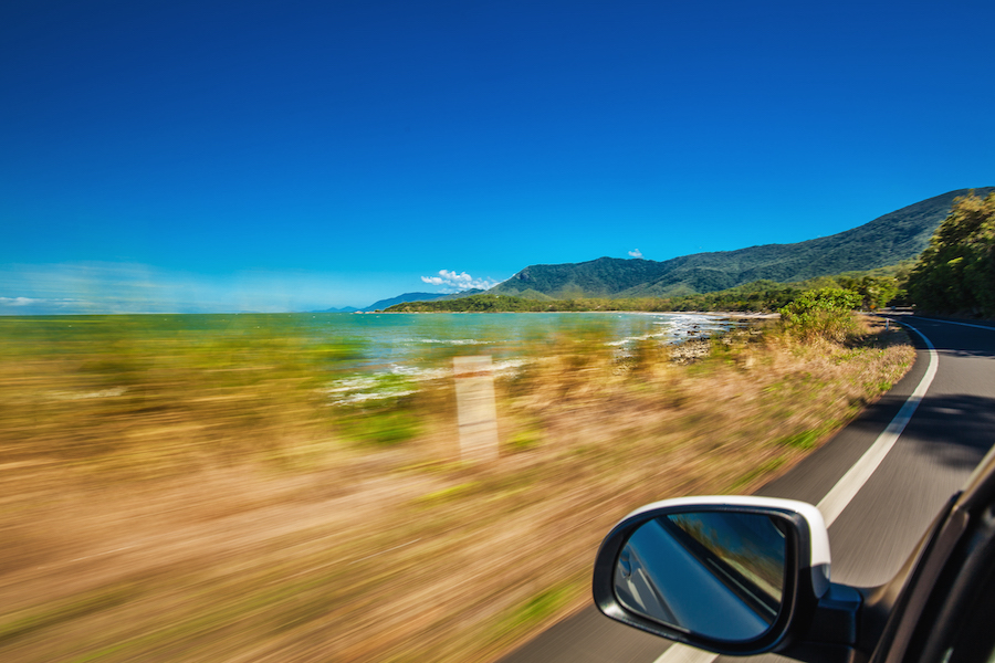 Road trip with motion blur along Ellis Beach near Palm Cove and Cairns, Australia