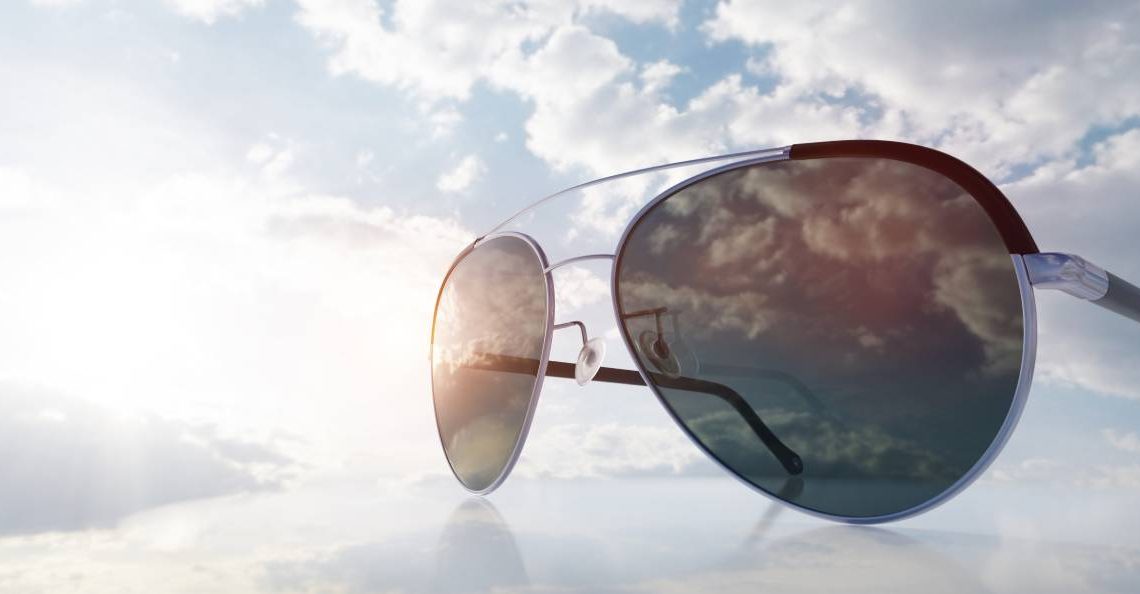 Polarized sunglasses on sunny sky. UV protection, polarization