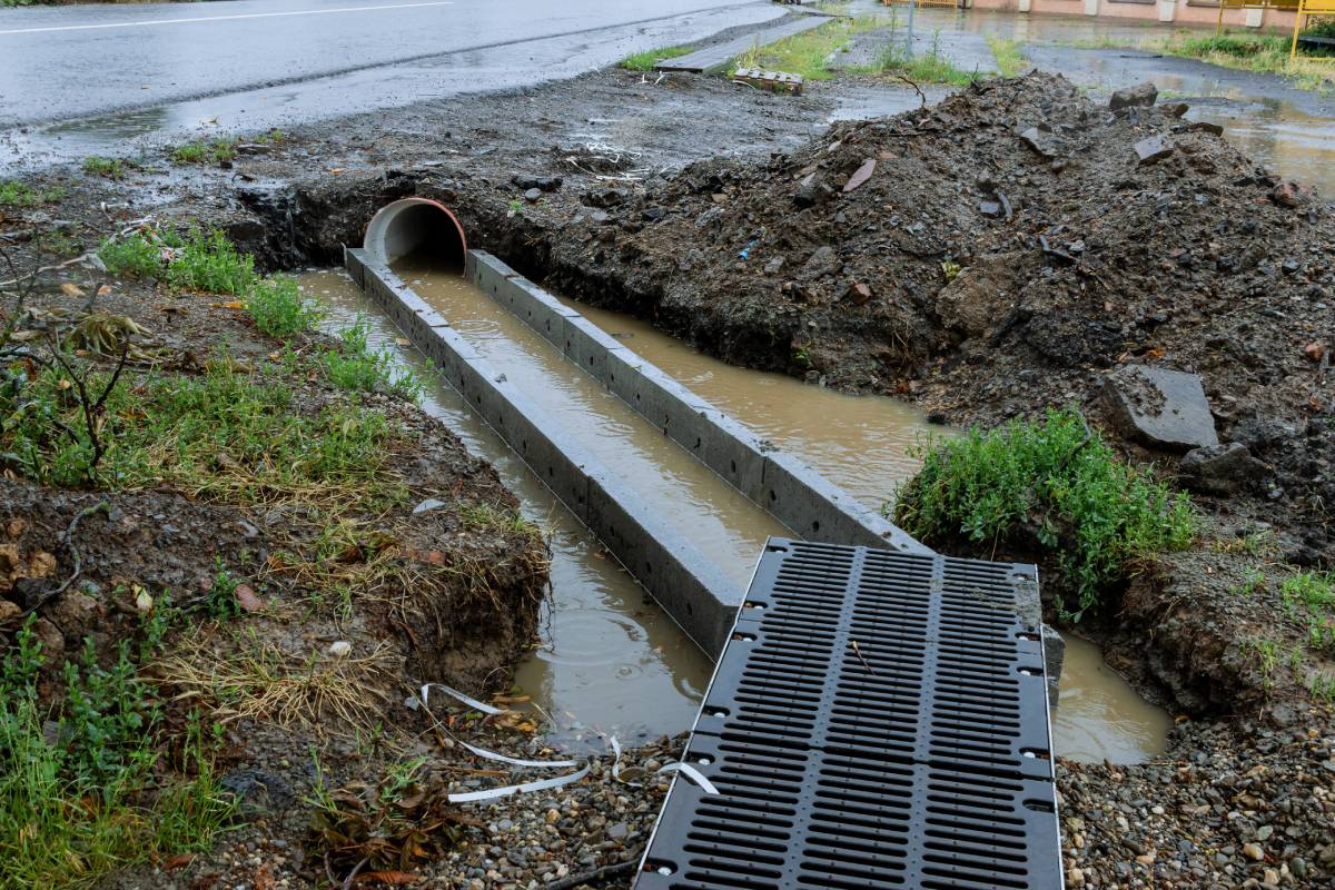 Heavy rain caused the canal to overflow and flood the surrounding area. Drainage system's water diversion channels effectively redirected excess water away from roads.