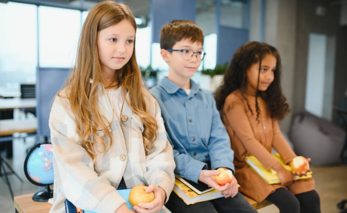 Multiracial schoolchildren having lunch at the desk during a break in school ADHD