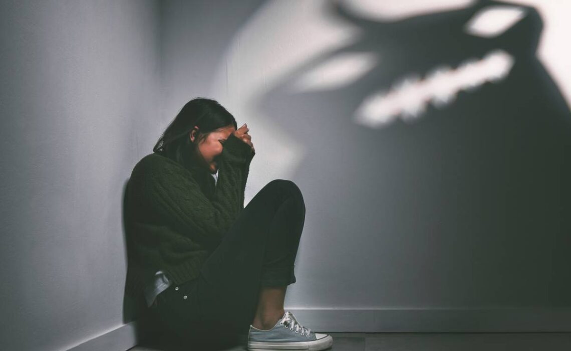 shot-of-a-young-woman-sitting-in-the-corner-of-a-d-2025-04-06-01-48-15-utc (1)