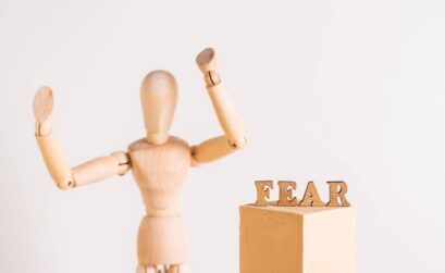 The word fear and a wooden man throwing up his hands in horror